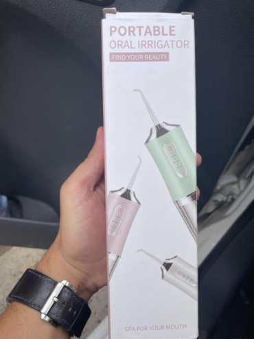 Portable oral irrigator